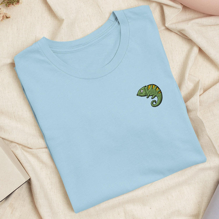 a blue t - shirt with a green chamelon embroidered on it