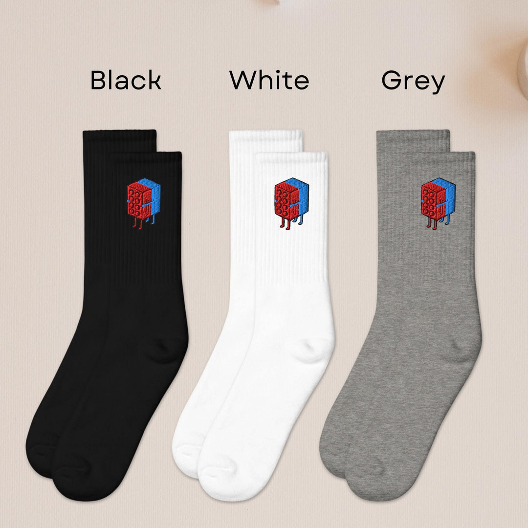 three pairs of black, white, and grey socks