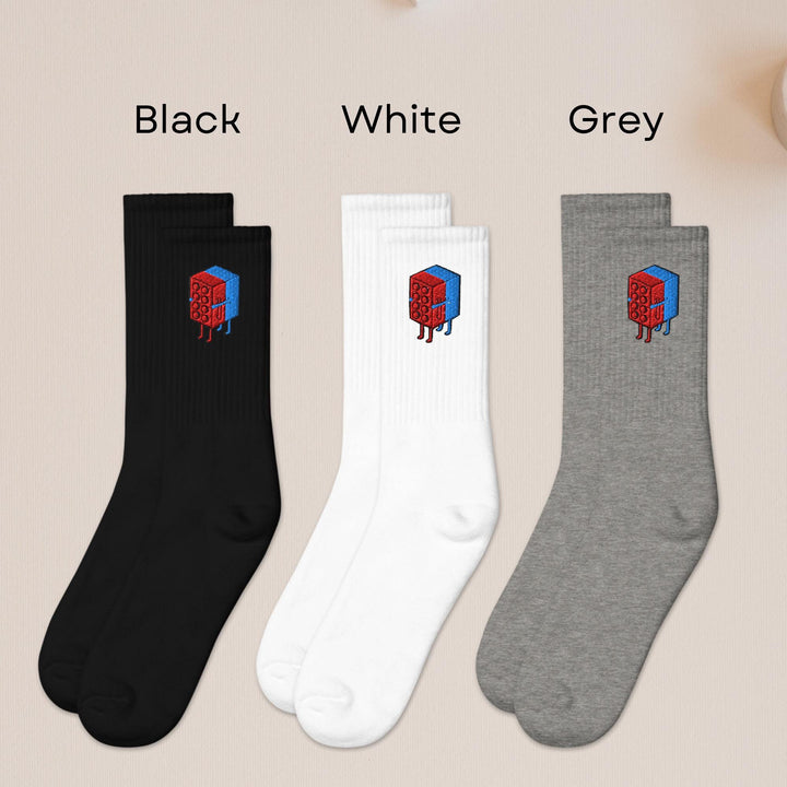 three pairs of black, white, and grey socks