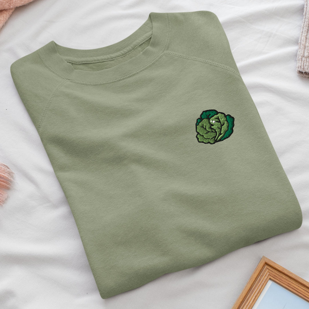 a green t - shirt with a picture of a cabbage on it