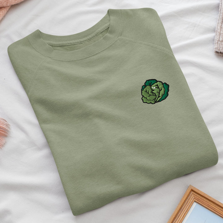 a green t - shirt with a picture of a cabbage on it