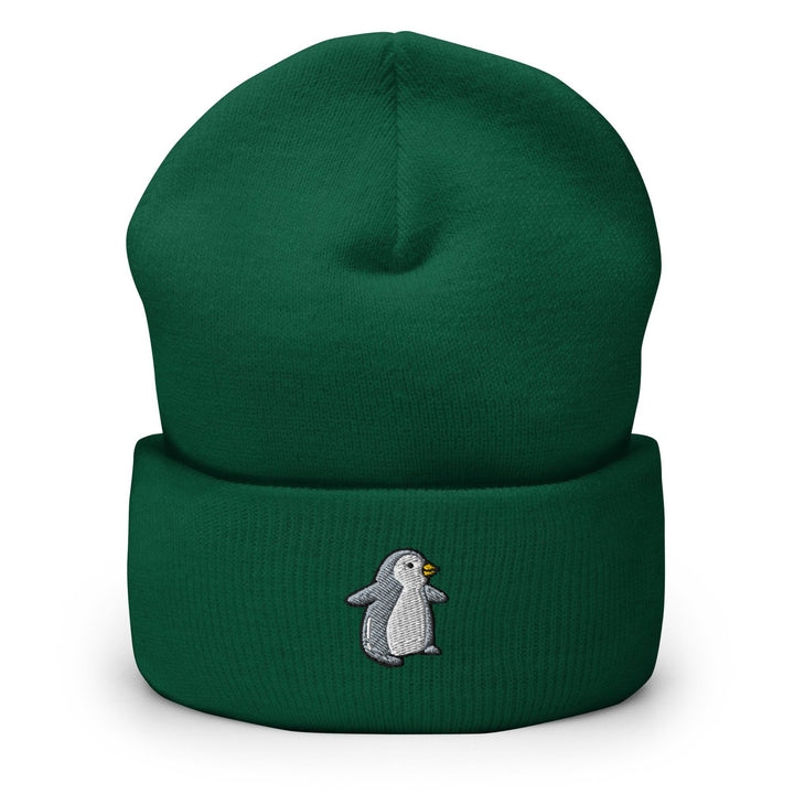 a green beanie with a penguin on it