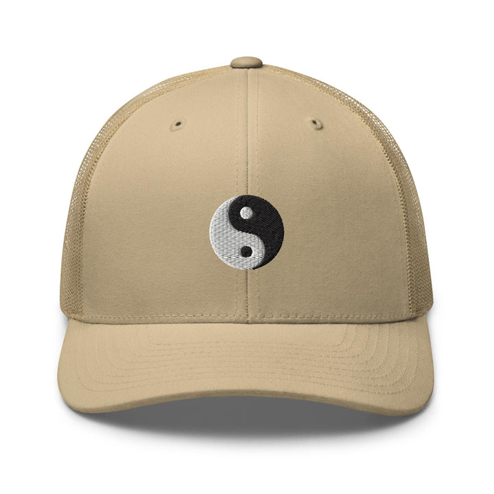 a tan hat with a black and white yin symbol on it