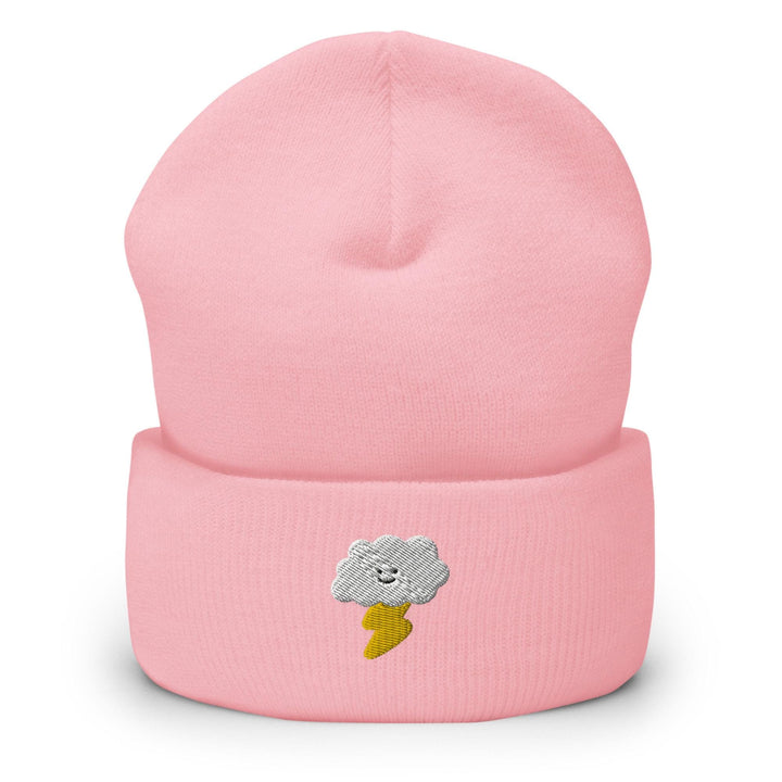 a pink beanie with a smiling cloud on it