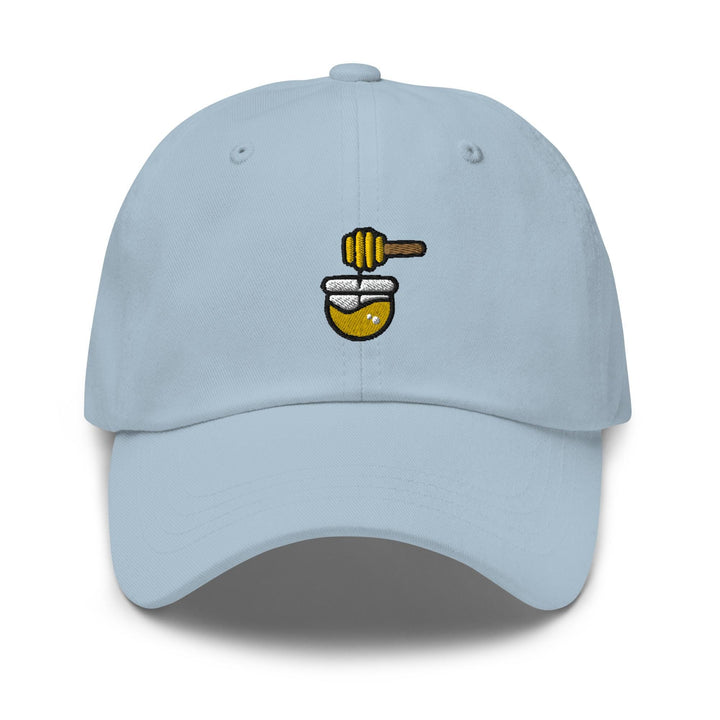 a light blue hat with a bee on it