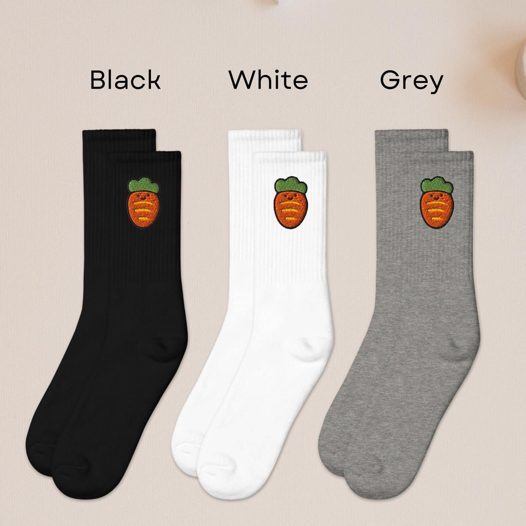 three pairs of black, white, and grey fruit socks