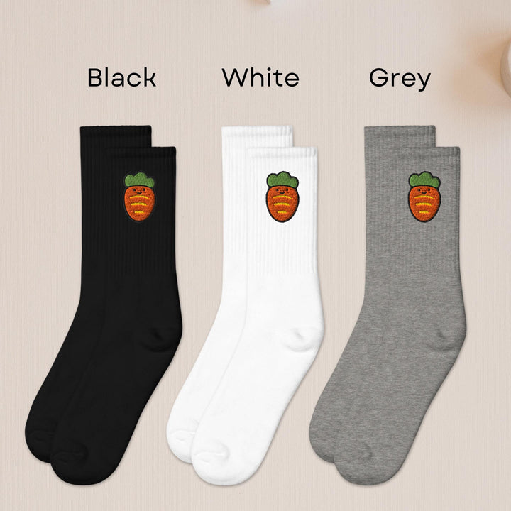 three pairs of black, white, and grey fruit socks
