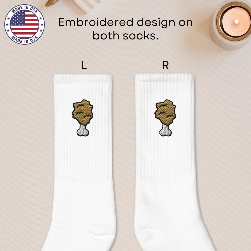 a pair of white socks with a brown bear on them