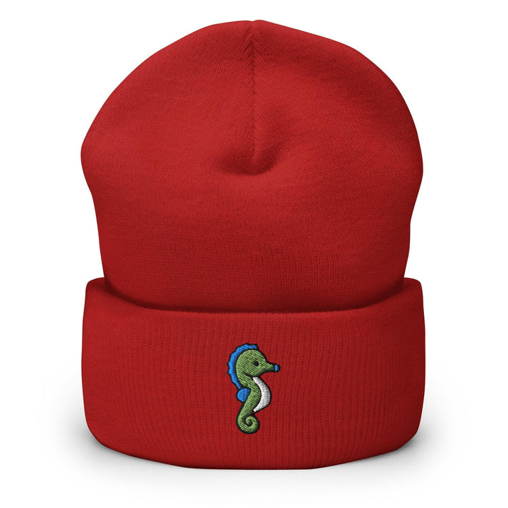 a red beanie with a seahorse embroidered on it