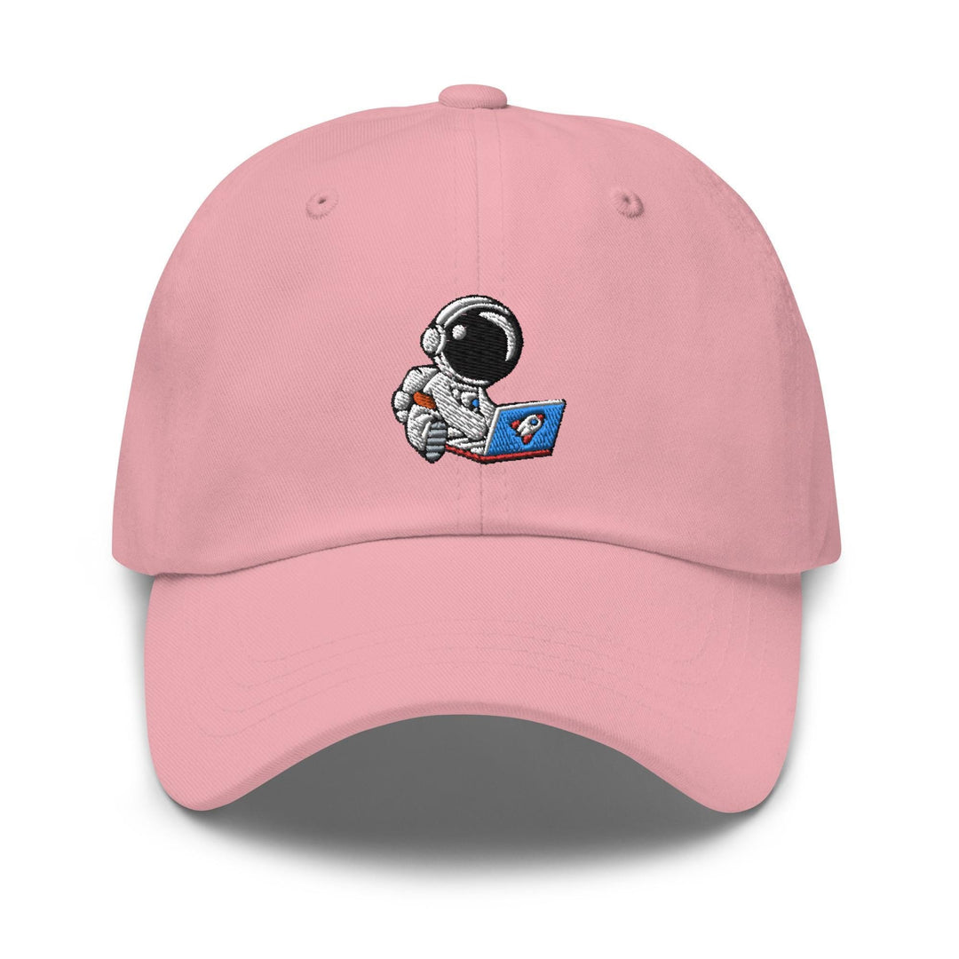 a pink hat with an astronaut reading a book