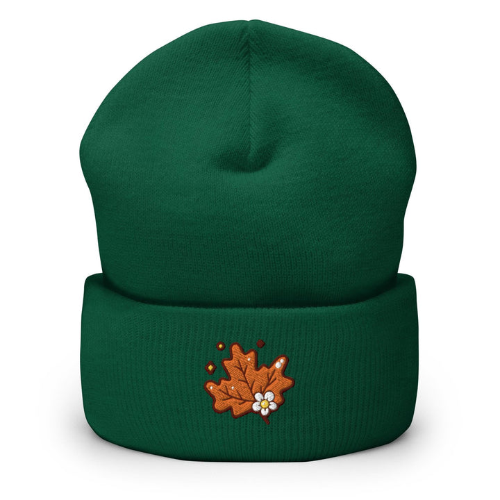 a green beanie with a picture of a maple on it