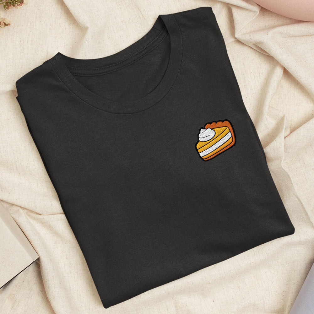 a black shirt with a piece of cake on it