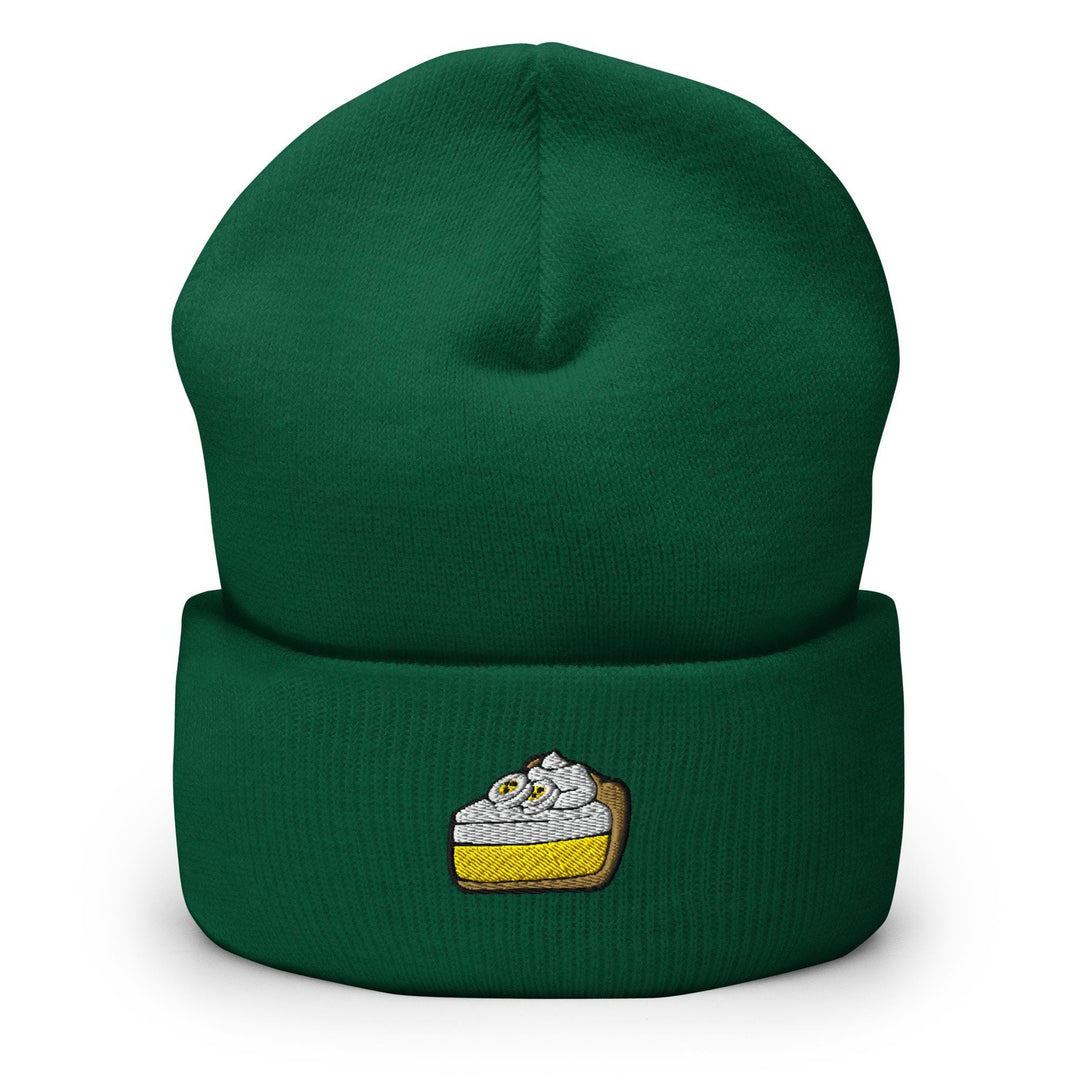 a green beanie with a piece of cake on it