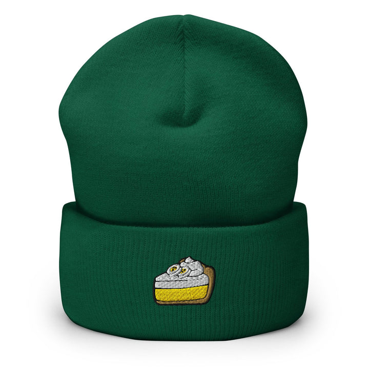 a green beanie with a piece of cake on it