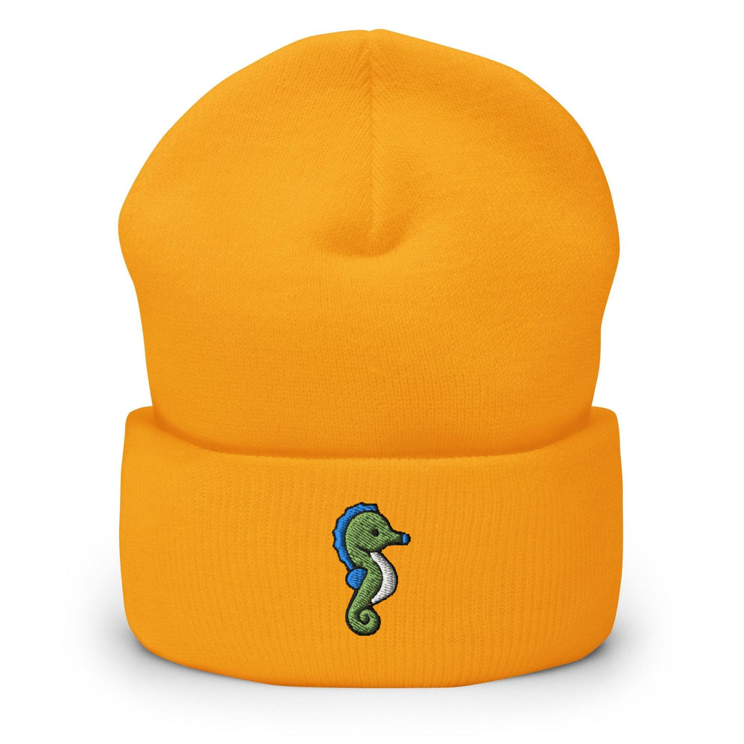 a yellow beanie with a seahorse embroidered on it
