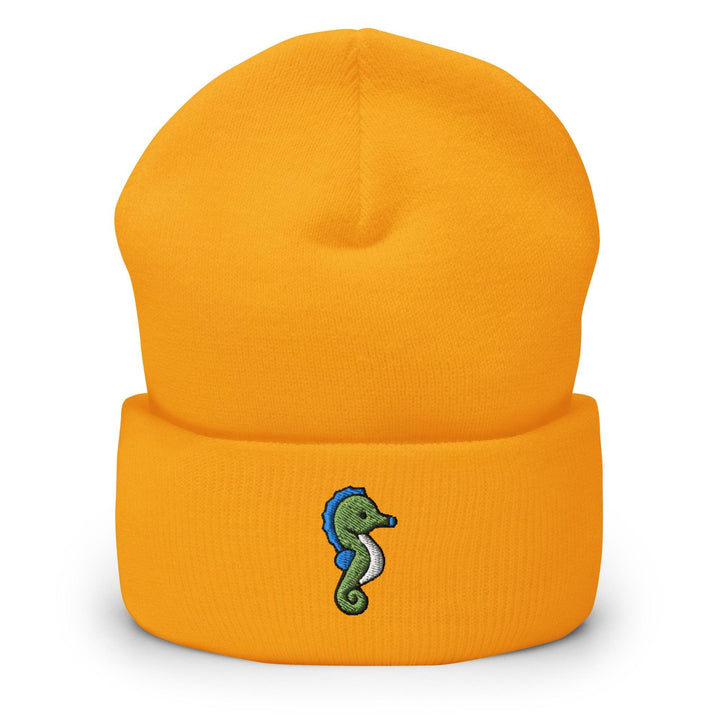 a yellow beanie with a seahorse embroidered on it