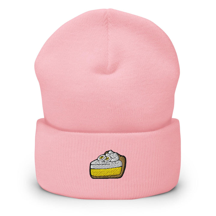 a pink beanie hat with a piece of cake on it