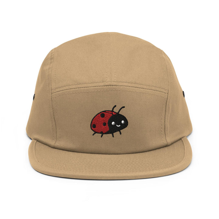 a tan hat with a ladybug embroidered on it