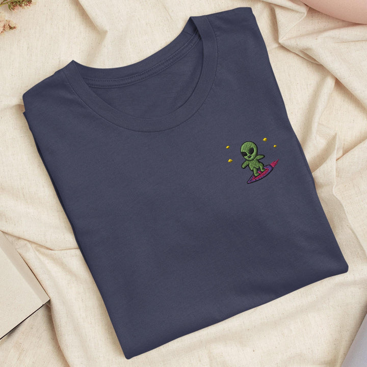 a blue t - shirt with an alien embroidered on it