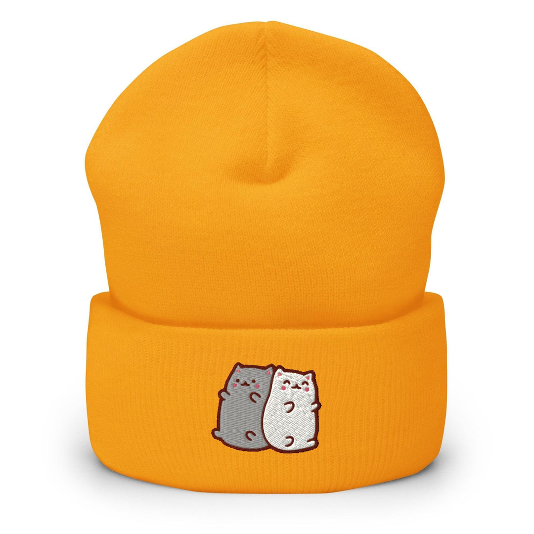 a yellow hat with two cats on it