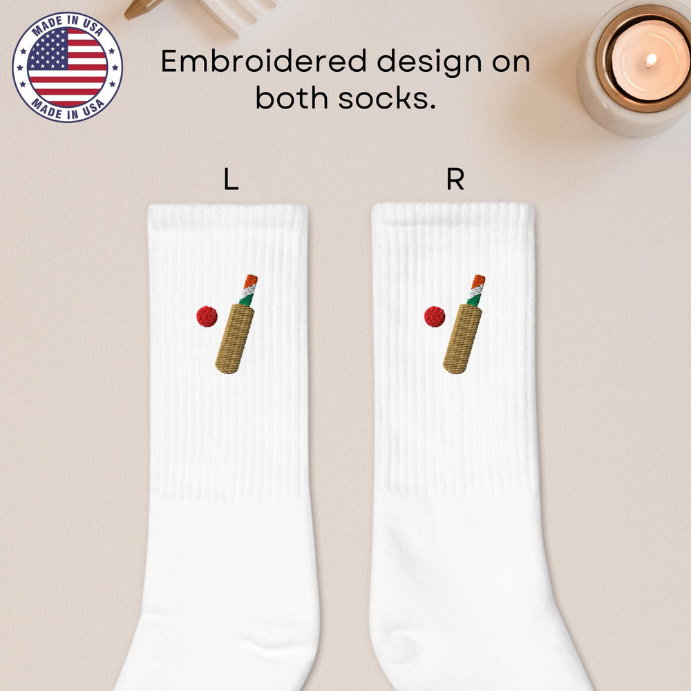 a pair of white socks with a bottle of wine and a candle