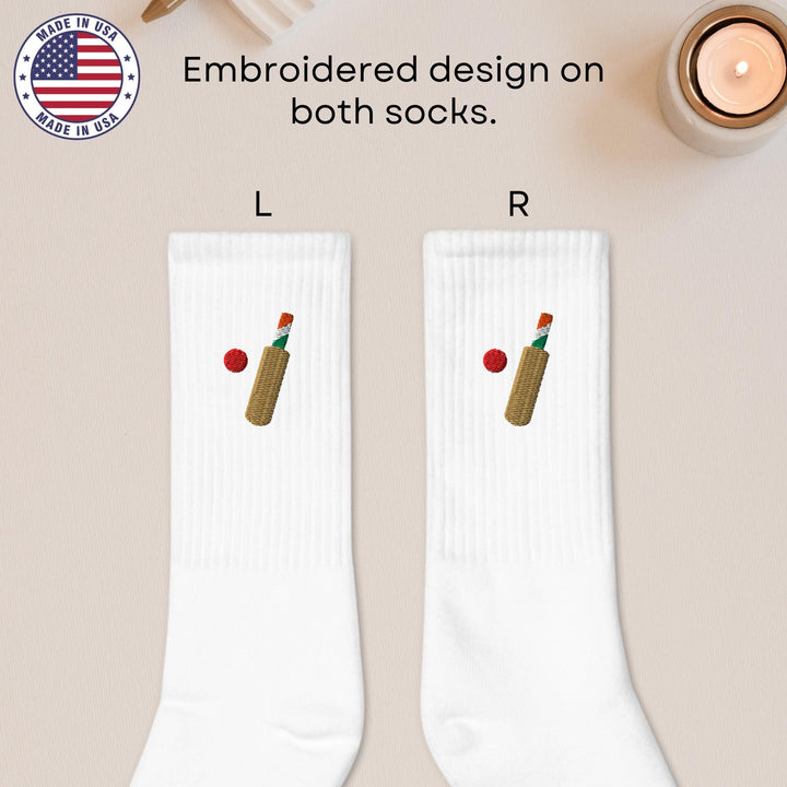 a pair of white socks with a bottle of wine and a candle
