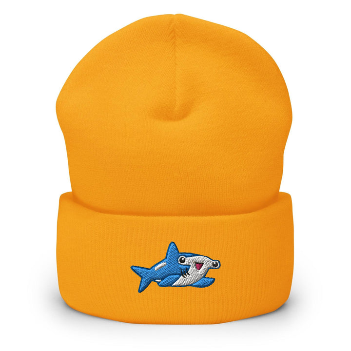 a yellow beanie with a cartoon shark on it