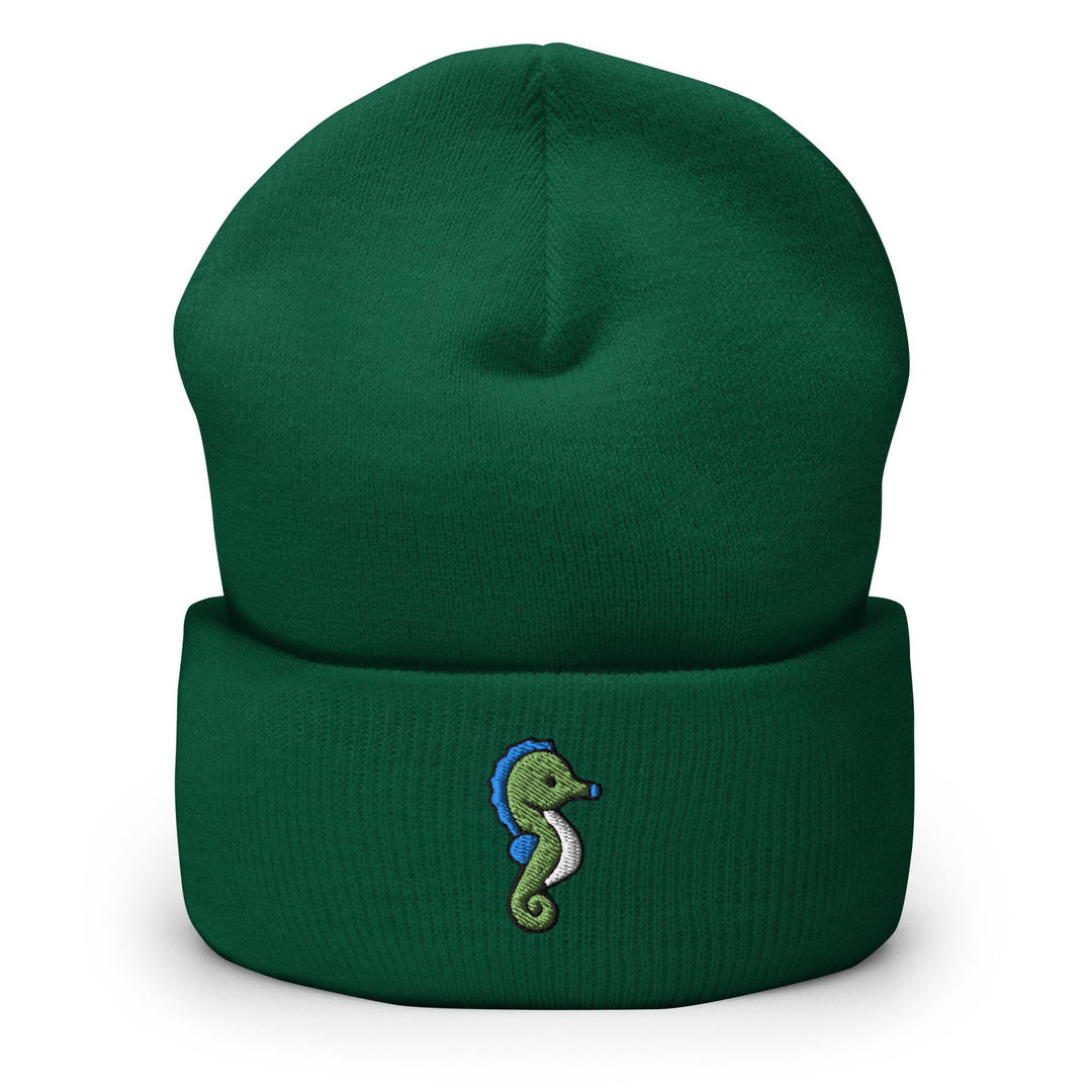 a green beanie with a seahorse embroidered on it