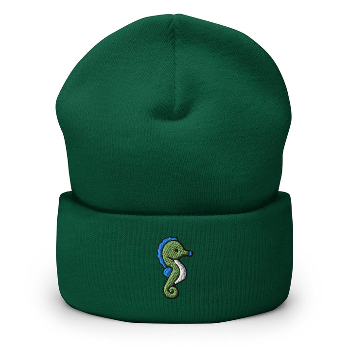 a green beanie with a seahorse embroidered on it