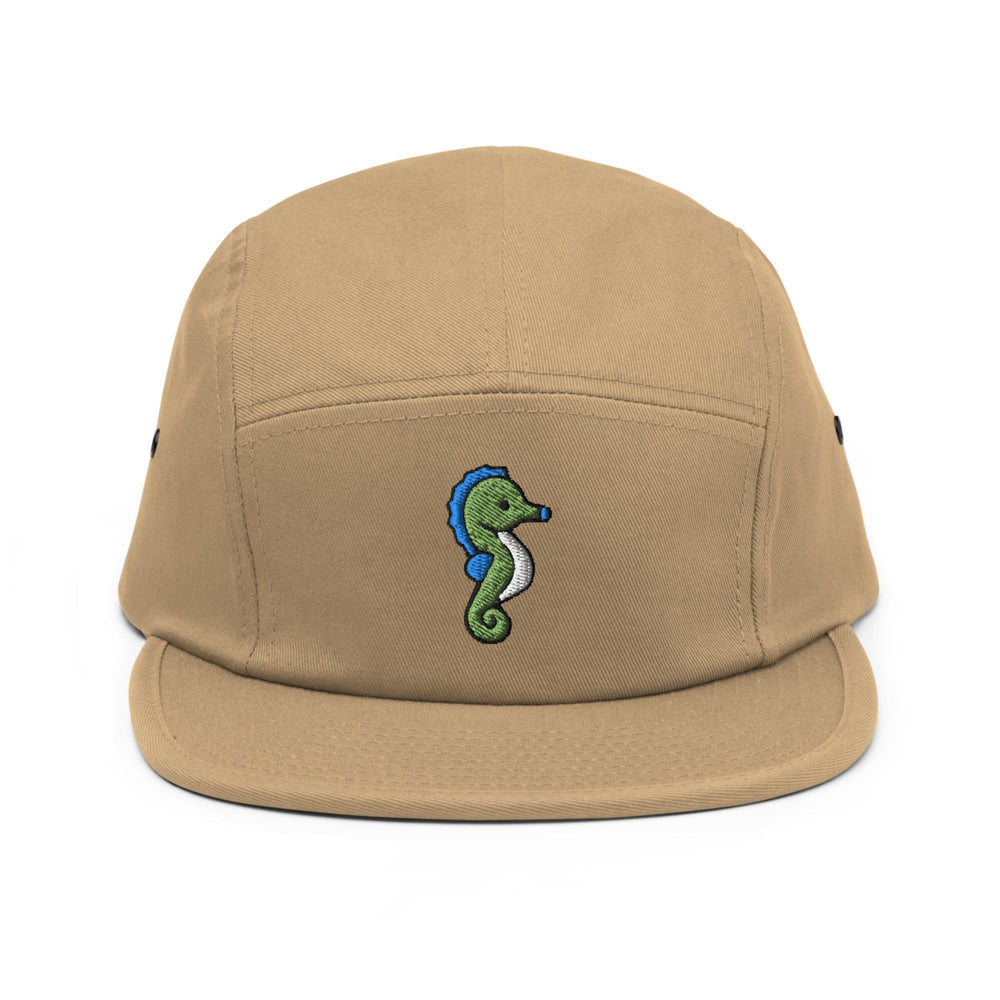 a tan hat with a green seahorse embroidered on it