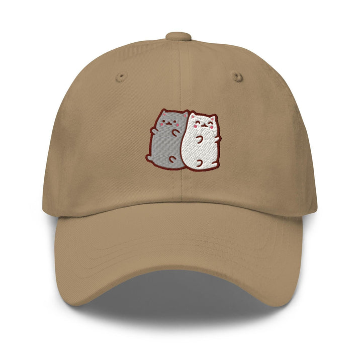 a tan hat with two cats on it