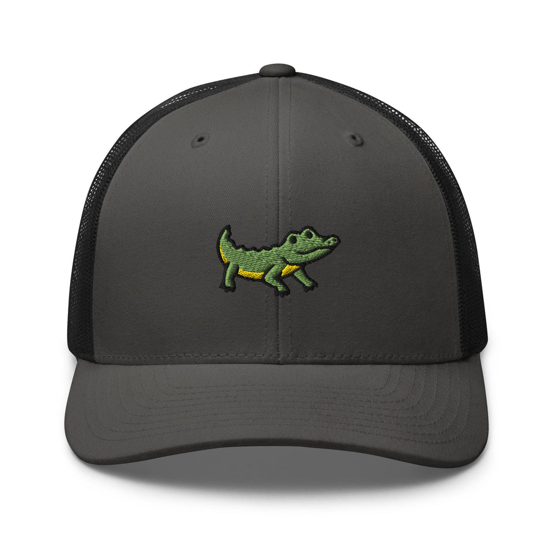 a gray and black trucker hat with a green alligator embroidered on the front