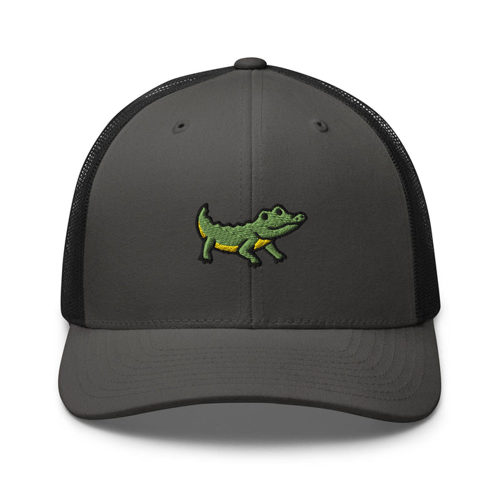a gray and black trucker hat with a green alligator embroidered on the front