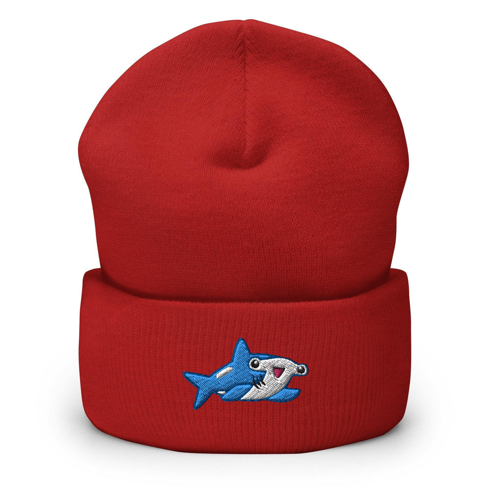 a red beanie with a cartoon shark on it