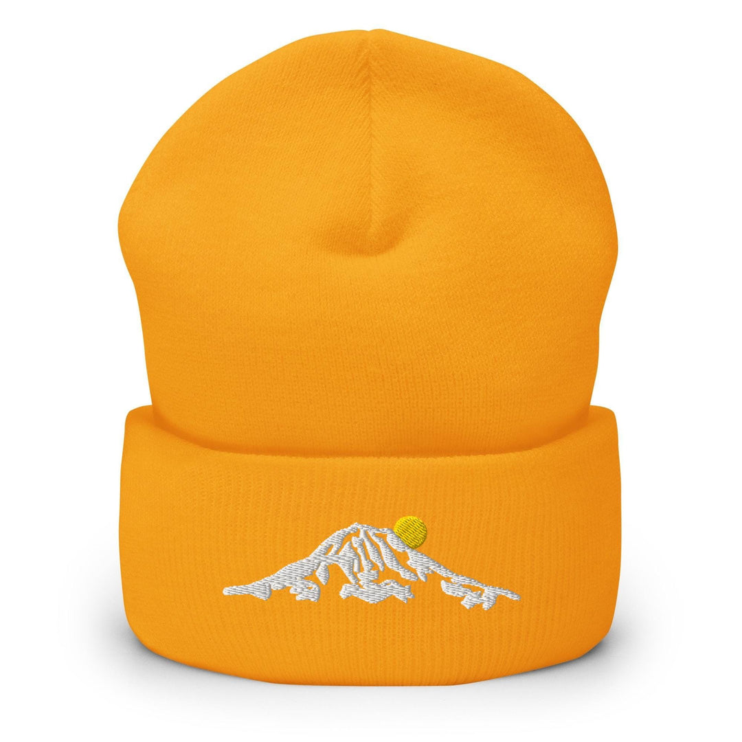 a yellow hat with a white mountain embroidered on it