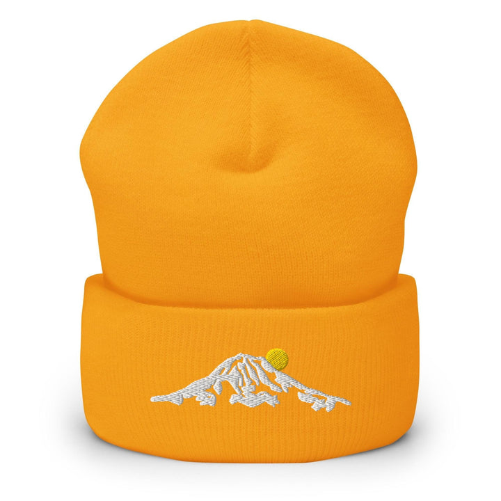a yellow hat with a white mountain embroidered on it