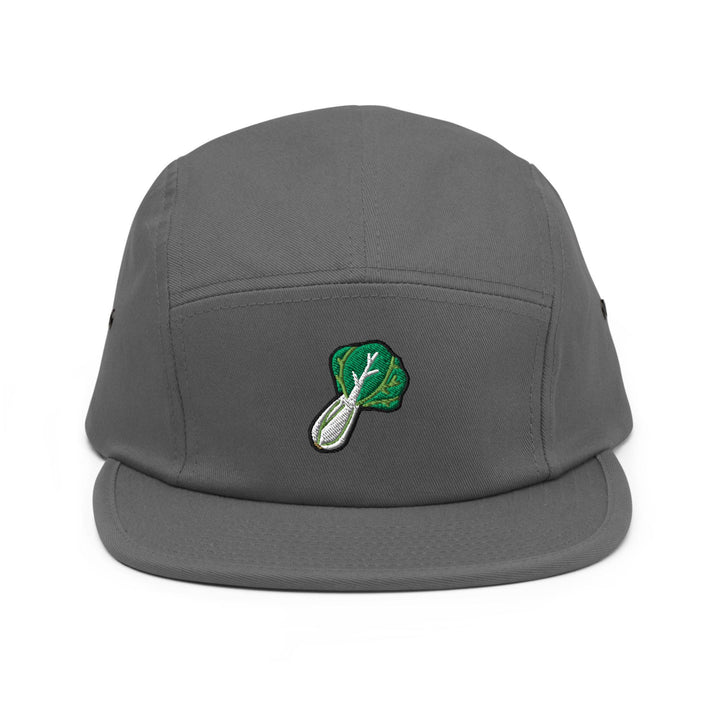 a gray hat with a green leaf on it