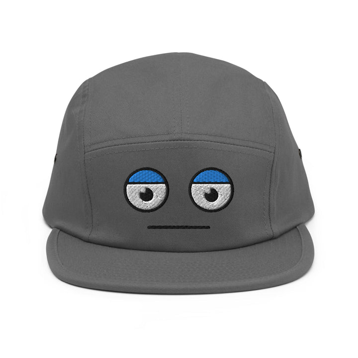a grey hat with eyes drawn on it