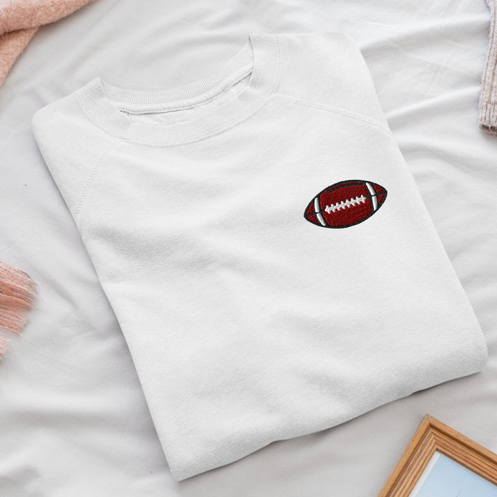 a white t - shirt with a football on it