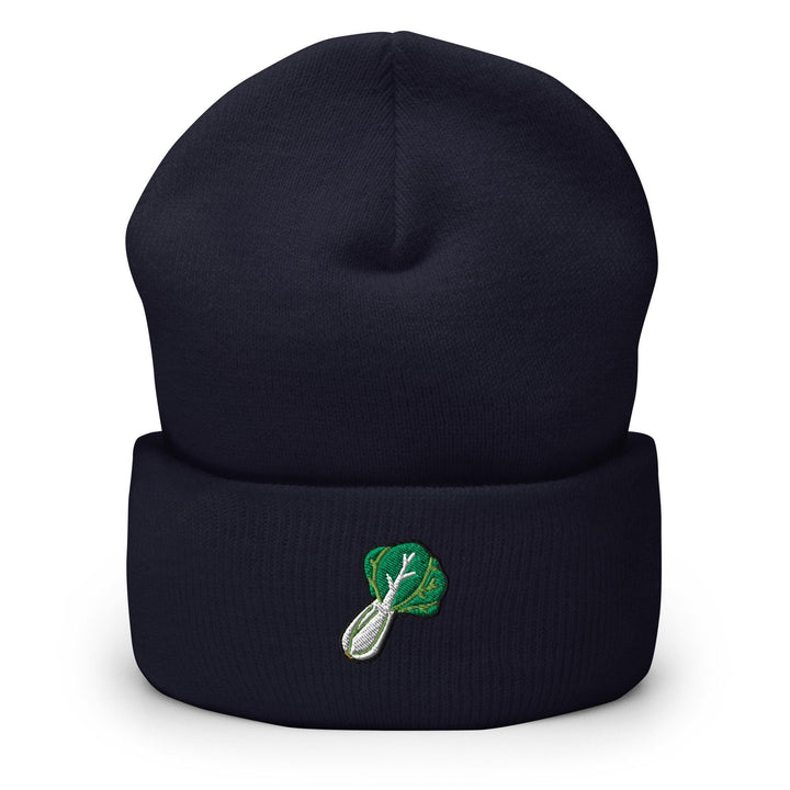a beanie with a green leaf on it