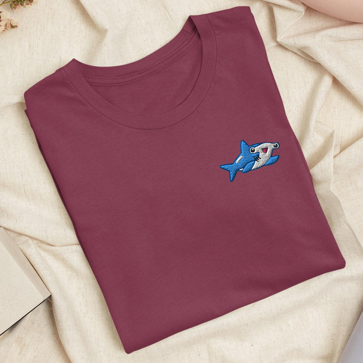 a t - shirt with a shark embroidered on it