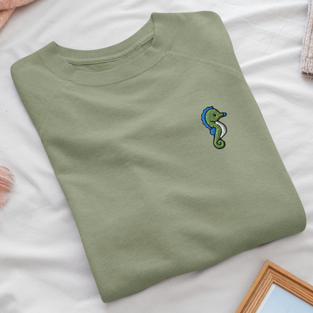 a green t - shirt with a green snake embroidered on it