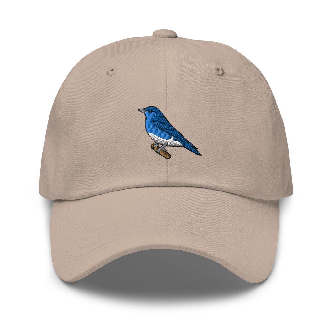 a tan hat with a blue bird embroidered on it