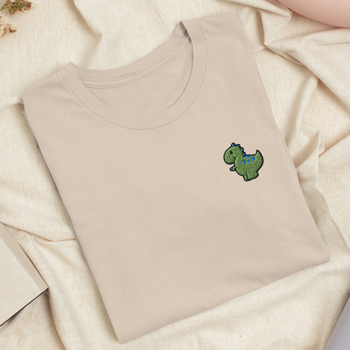 a t - shirt with a dinosaur embroidered on it