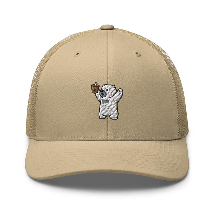 a tan trucker hat with a picture of a bear holding a piece of cake