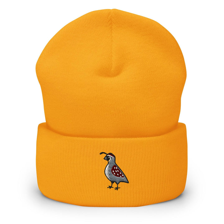 a yellow beanie with a bird embroidered on it