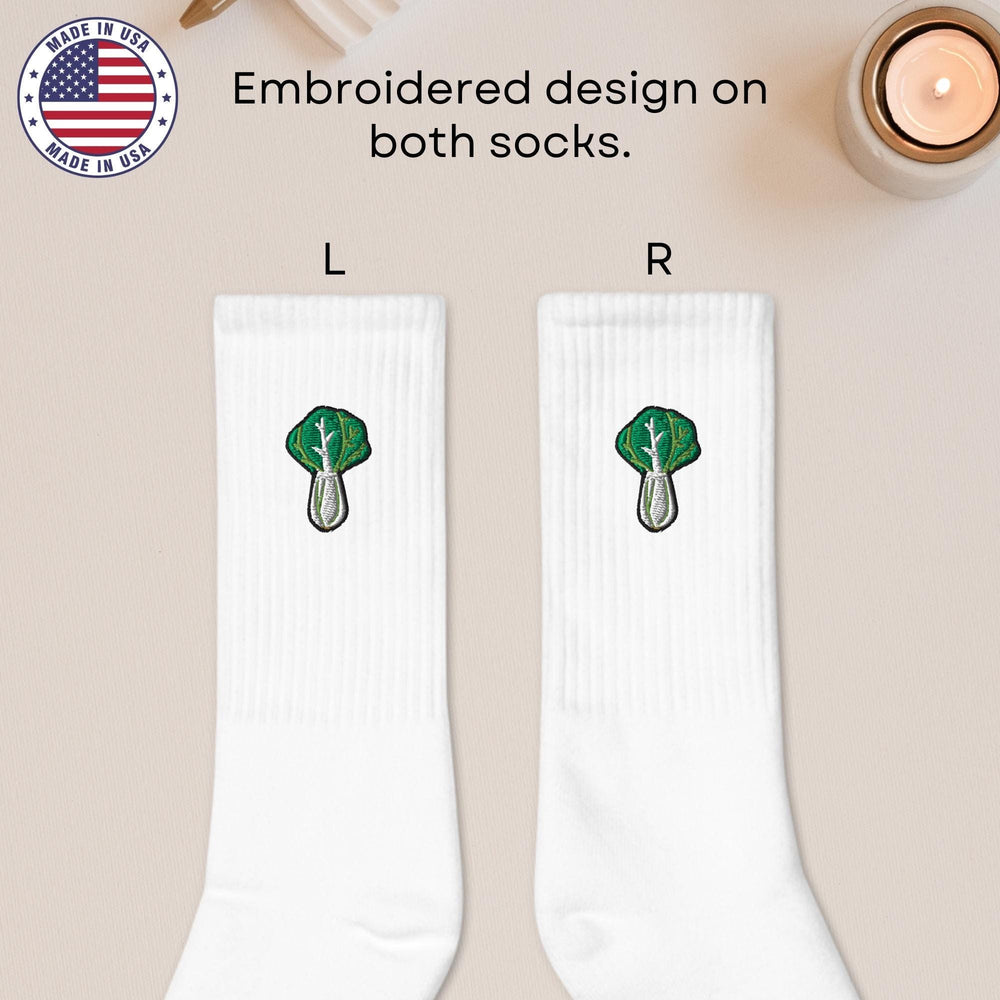 a pair of white socks with a green tree on them