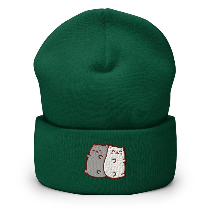 a green beanie with two cats on it