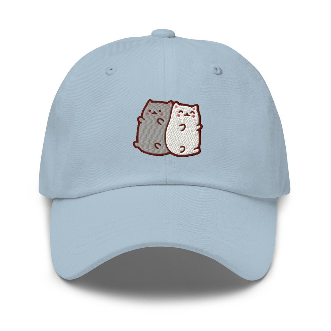 a light blue hat with two cats on it