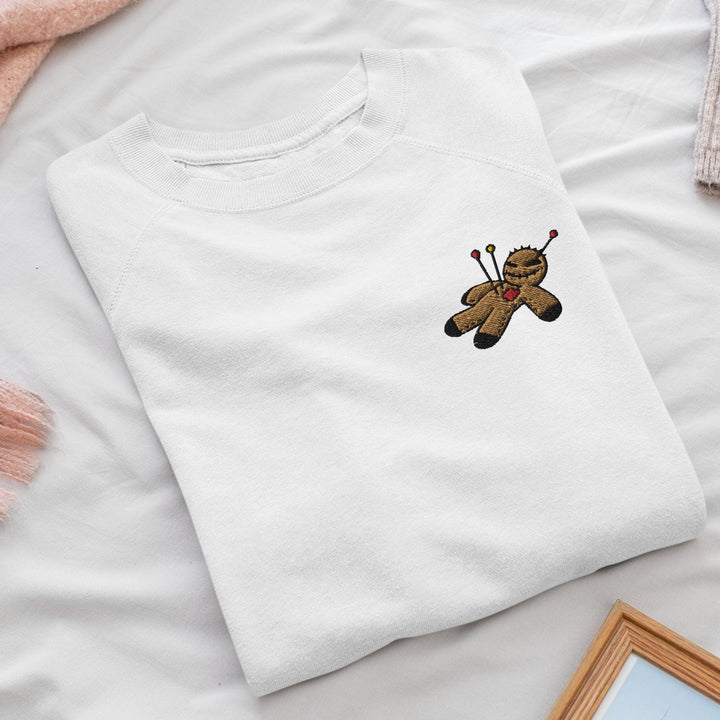 a white t - shirt with a teddy bear embroidered on it